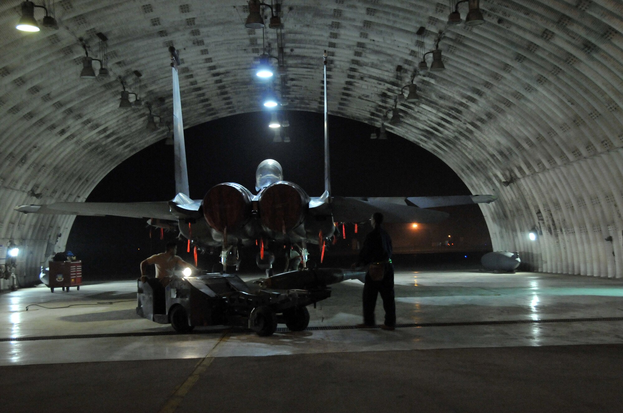Staff Sgt. Dominique Battle, weapons load team chief, steadies the loading of a  Mark 82 onto an F-15 as Airman 1st Class Ari Valdez, weapons load crew member, steers a "jammer" at Kunsan Air Base, Republic of Korea, Sept. 17. Sergeant Battle and Airman Valdez are assigned to the 389th Expeditionary Fighter Squadron, deployed from Mountain Home Air Force Base, Idaho. Throughout the week, 389th EFS weapons loaders, along with other Airmen and pilots, trained with live munitions. (U.S. Air Force photo/Capt. Shannon Collins) 
