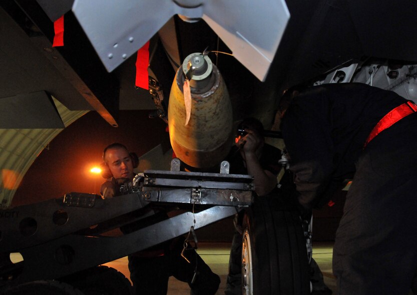 Staff Sgt. Matthew Modgling, weapons load team chief, Tech. Sgt. Jeremy Stradtmann, weapons expediter, and Senior Airman Donald Williams, weapons load crew member, load live Mark 82s onto an F-15 at Kunsan Air Base, Republic of Korea, Sept. 17. Sergeants Modgling and Stradtmann, along with Airman Williams, are assigned to the 389th Expeditionary Fighter Squadron, deployed from Mountain Home Air Force Base, Idaho. Throughout the week, 389th EFS weapons loaders, along with other Airmen and pilots, trained with live munitions. (U.S. Air Force photo/Capt. Shannon Collins) 