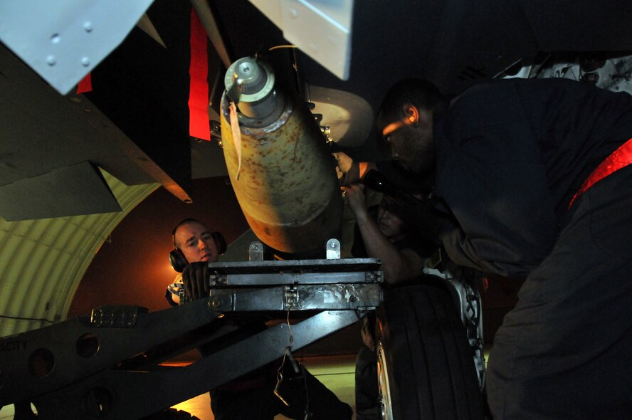Staff Sgt. Matthew Modgling, weapons load team chief, Tech. Sgt. Jeremy Stradtmann, weapons expediter, and Senior Airman Donald Williams, weapons load crew member, load live Mark 82s onto an F-15 at Kunsan Air Base, Republic of Korea, Sept. 17. Sergeants Modgling and Stradtmann, along with Airman Williams, are assigned to the 389th Expeditionary Fighter Squadron, deployed from Mountain Home Air Force Base, Idaho. Throughout the week, 389th EFS weapons loaders, along with other Airmen and pilots, trained with live munitions. (U.S. Air Force photo/Capt. Shannon Collins) 