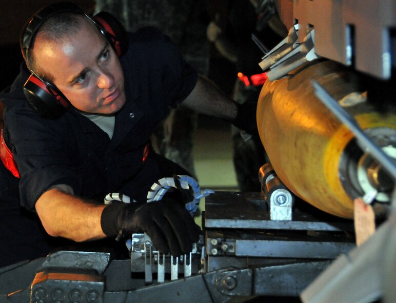 Staff Sgt. Matthew Modgling, weapons load team chief, secures a "live" Mark 82 onto an F-15 at Kunsan Air Base, Republic of Korea, Sept. 17. Sergeant Modgling is assigned to the 389th Expeditionary Fighter Squadron, deployed from Mountain Home Air Force Base, Idaho. Throughout the week, 389th EFS weapons loaders like Sergeant Modgling, along with other Airmen and pilots, trained with live munitions. (U.S. Air Force photo/Capt. Shannon Collins) 