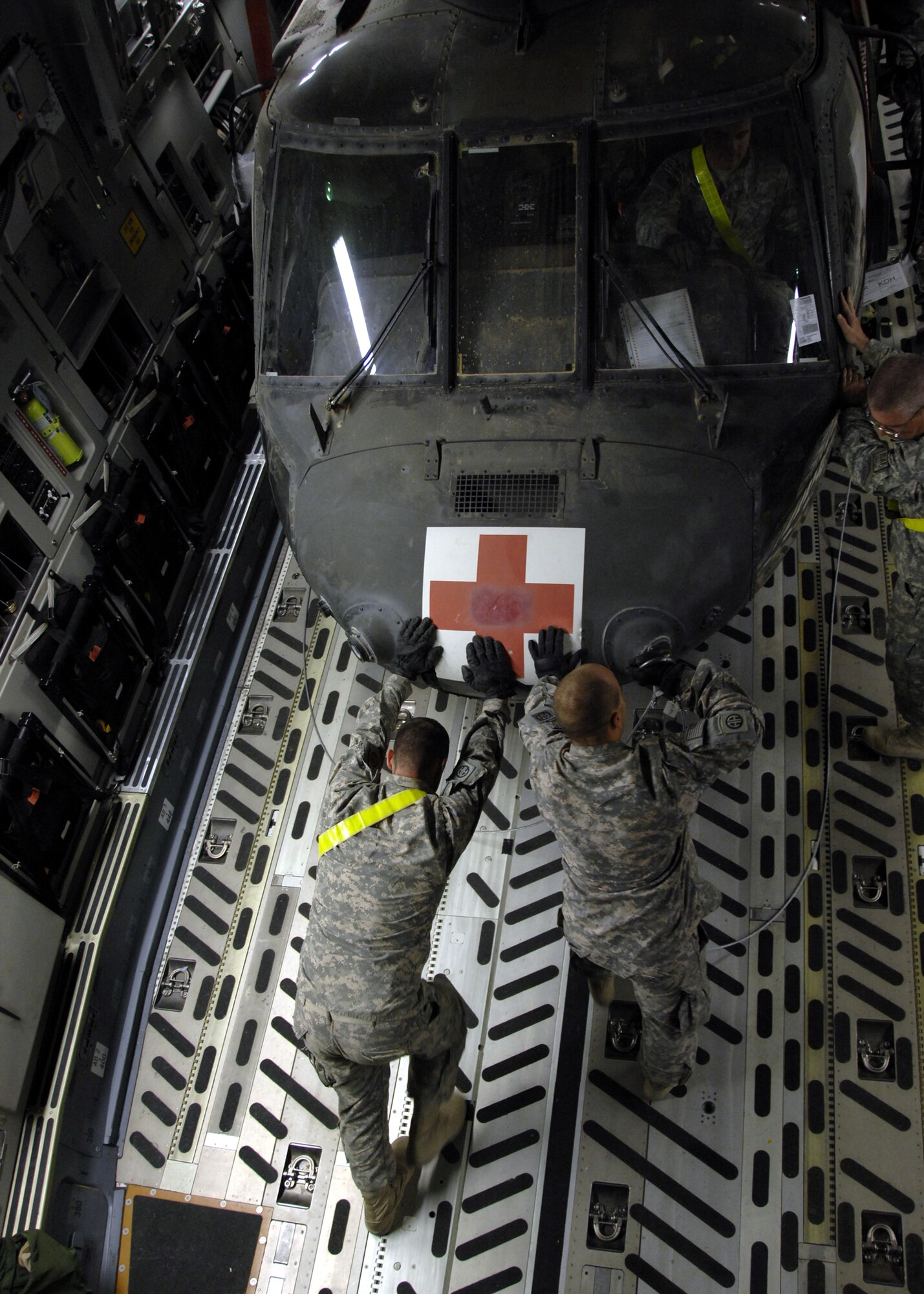 Soldiers and Airmen at Kandahar Airfield, Afghanistan, unload three medical HH-60 Pave Hawks from a C-17 Globemaster III, Oct. 16, 2009. Some of the Pave Hawks functions and missions are civil search and rescue, emergency aeromedical evacuation and international aid. (U.S. Air Force photo/Senior Airman Timothy Taylor)