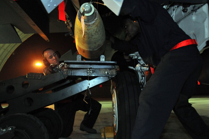 Staff Sgt. Matthew Modgling, weapons load team chief, and Senior Airman Donald Williams, weapons load crew member, load live Mark 82s onto an F-15 at Kunsan Air Base, Republic of Korea, Sept. 17. Sergeant Modgling and Airman Williams are assigned to the 389th Expeditionary Fighter Squadron, deployed from Mountain Home Air Force Base, Idaho. Throughout the week, 389th EFS weapons loaders, along with other Airmen and pilots, trained with live munitions. (U.S. Air Force photo/Capt. Shannon Collins) 