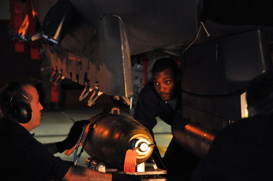 Staff Sgt. Matthew Modgling, weapons load team chief, and Senior Airman Donald Williams, weapons load crew member, steady a live Mark 82 onto an F-15 at Kunsan Air Base, Republic of Korea, Sept. 17. Sergeant Modgling and Airman Williams are assigned to the 389th Expeditionary Fighter Squadron, deployed from Mountain Home Air Force Base, Idaho. Throughout the week, 389th EFS weapons loaders, along with other Airmen and pilots, trained with live munitions. (U.S. Air Force photo/Capt. Shannon Collins) 