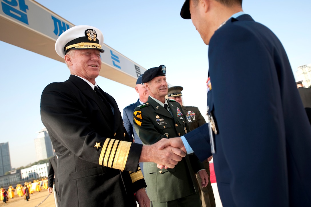 U.S. Navy Adm. Robert F. Willard, the commander of U.S. Pacific Command, left,  and U.S. Army Gen. Skip Sharp, second from left, the commander of U.S. Forces Korea, greet Republic of Korea military officers during a welcoming ceremony in Seoul, South Korea, Oct. 21, 2009.