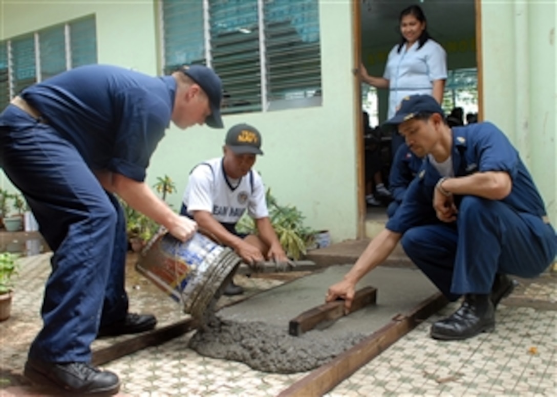 U.S. Navy Chief Petty Officer Randy Bell and Senior Chief Petty Officer Albert Puyot, both assigned to the amphibious dock landing ship USS Tortuga (LSD 46), along with a sailor from the Philippine navy, work on construction projects at Sangley Point National High School in Cavite, Philippines, on Oct. 15, 2009.  The Tortuga, amphibious dock landing ship USS Harpers Ferry (LSD 49) and the 31st Marine Expeditionary Unit are participating in PHIBLEX 09, an exercise designed to improve interoperability, increase readiness and develop professional relationships between the U.S. military and the Armed Forces of the Philippines.  