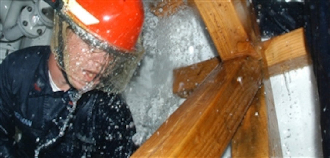 U.S. Navy Petty Officer 2nd Class Ken Wiseman secures the K-type shoring during damage control training at the Center of Naval Engineering Learning Site, Naval Station Pearl Harbor, Hawaii, on Oct. 20, 2009.  The Surface Damage Control Trainer simulates conditions on the USS Samuel B. Roberts when the ship struck a mine in the Persian Gulf in April 1988.  