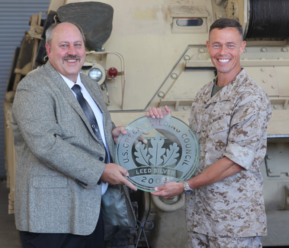 Kevin McBride, vice president for N.C. VIRTEXCO Corp., presents the award to Col. Richard P. Flatau Jr., the commanding officer for Marine Corps Base Camp Lejeune, recently during the Leadership in Energy and Environmental Design Silver certification ceremony, for the building of SR-72, Reserve Training Center and Tank Maintenance Facility in the Greater Sandy Run area. Flatau said it was an honor for Lejeune to receive this award and lead the example in this achievement.