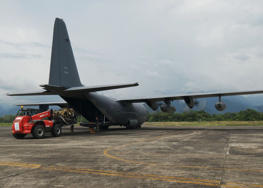 PADANG, Indonesia --Airmen from the 353rd Special Operations Group load humanitarian supplies onto a MC-130P Combat Shadow at Tabing Air Field Oct. 13. More than 65 members of the group provided their unique expertise in key areas to multiple organizations supporting relief efforts across the affected area. (U.S. Air Force photo by Staff Sgt. Veronica Pierce)