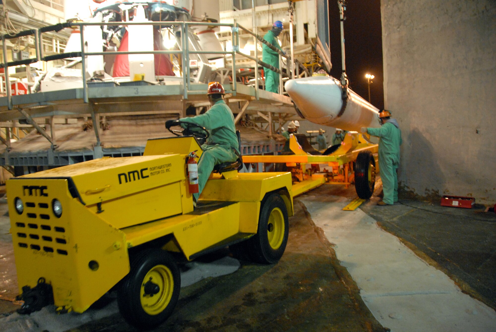 VANDENBERG AIR FORCE BASED, Calif. --  United Luanch Alliance workers lift a solid rocket motor for emplacement on a Delta II rocket. The Delta II rocket will launch NASA's Wide-field Infrared Survey Explorer satellite, which will observe the entire sky in mid-infrared wavelengths with greater sensitivity than ever before. (Courtesy photo/Mark P. Mackley)
