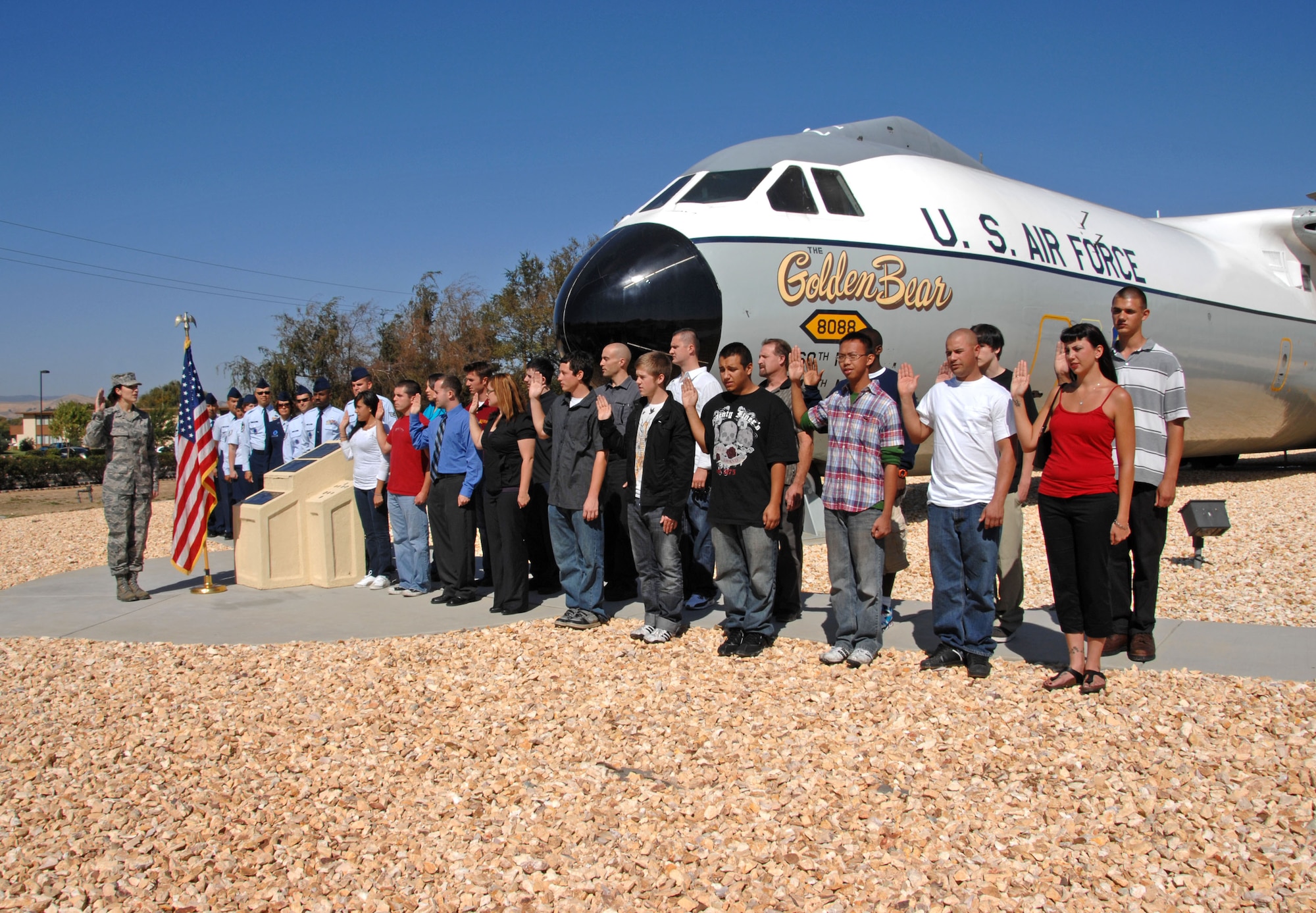 TRAVIS AIR FORCE BASE, Calif. -- The 349th Air Mobility Wing swears in a group of recruits during a mass enlistment in front of the "Golden Bear' on Sept. 17.  This group of men and women helped the Air Force Reserve Command reach its recruiting goal for 2009. (U.S. Air Force photo/Nan Wylie)