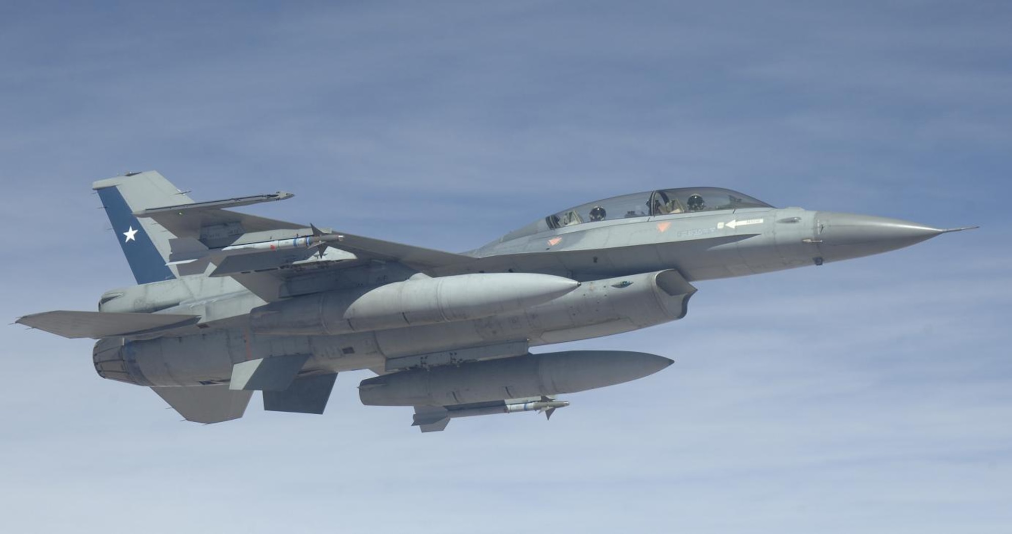 IQUIQUE, Chile – A Chilean F-16 flies on the wingtip of a U.S. KC-135 Stratotanker after refueling Oct. 22. The Fuerza Aérea de Chile or FACh hosted the United States, Brazil, Argentina, and France during Exercise SALITRE II, a multinational exercise focused on interoperability. (U.S. Air Force photo by Tech. Sgt. Eric Petosky)