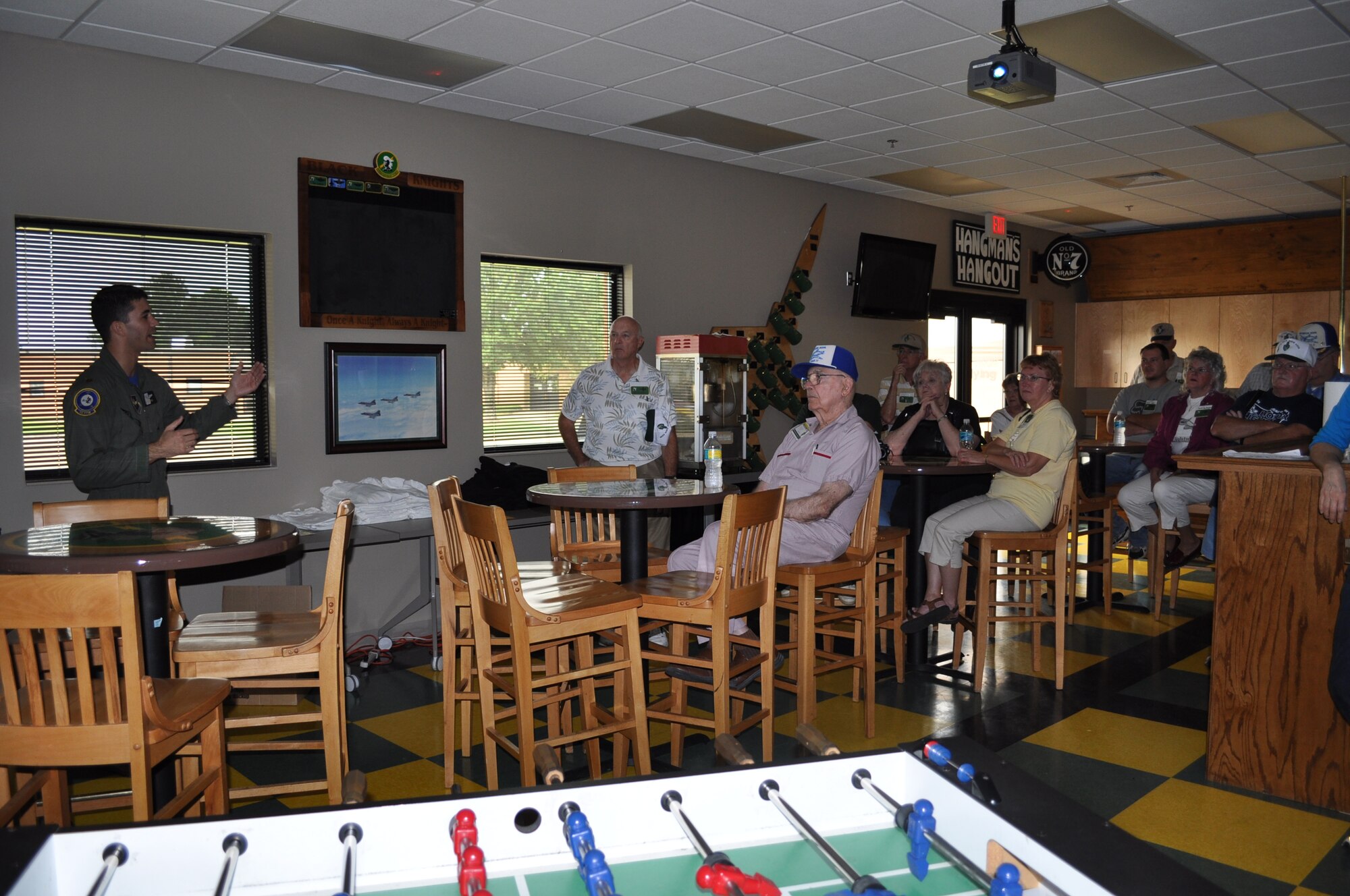 In the 49th Fighter Training Squadron Heritage Room Maj. Nathan Smith gives a wing mission briefing to members of the 49th Fighter Squadron Association during their reunion tour.  (U.S. Air Force photo/Sonic Johnson).