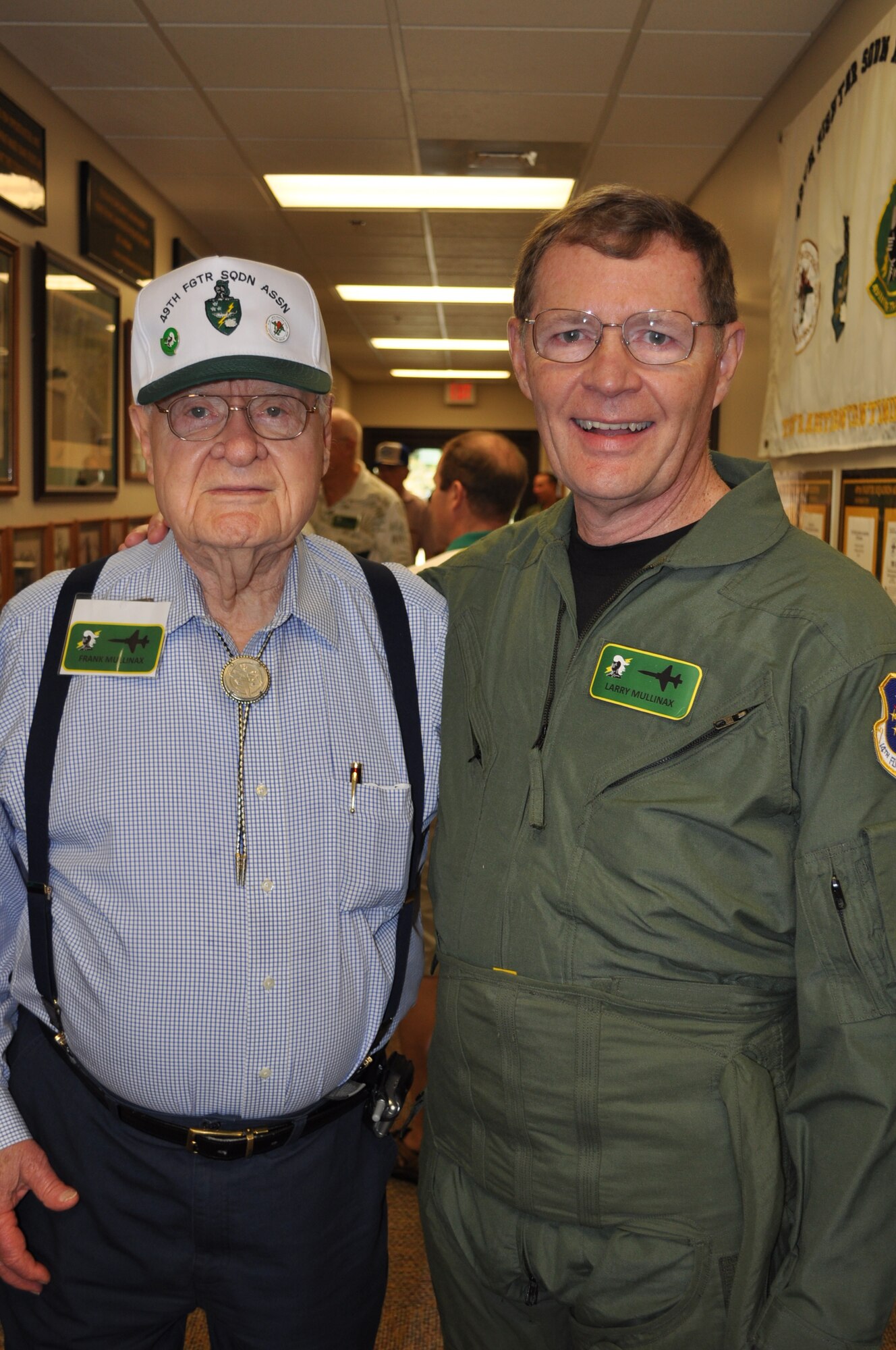 Mr. Frank Mullinax, 49th WWII P-38 pilot and former POW, stands with his son Larry in the 49th Fighter Training Squadron Heritage Hallway. (U.S. Air Force photo/Sonic Johnson).