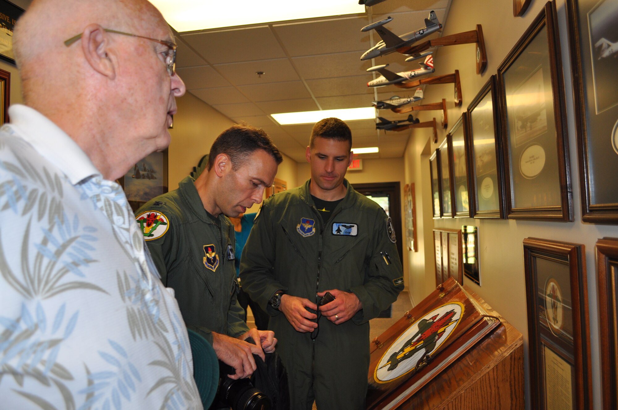 Lt. Col. Tor Dietrichs and Capt. Nick Graham of the 49th Fighter Training Squadron stand in the 49th FTS Heritage Hall during the 49th Fighter Squadron Association reunion tour. (U.S. Air Force photo/Sonic Johnson).