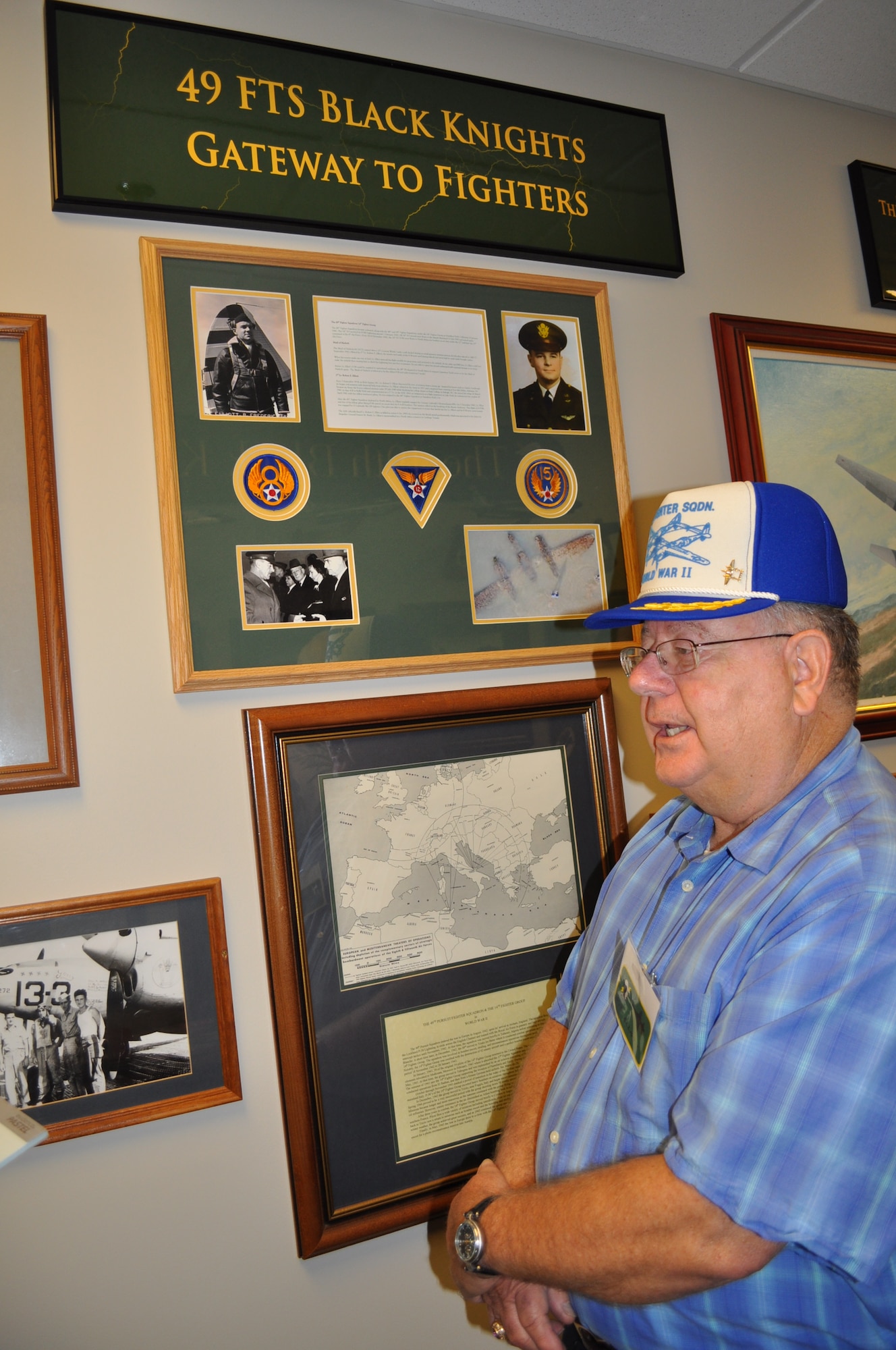 Mr. Bob Elliot stands by a commemoration to his uncle Lt. Robert F. Elliot at the 49th Fighter Training Squadron.  Lt. Elliot, a member of the 49th Fighter Squadron, was killed in action when his P-38 was shot down over North Africa during WWII. (U.S. Air Force photo/Sonic Johnson).