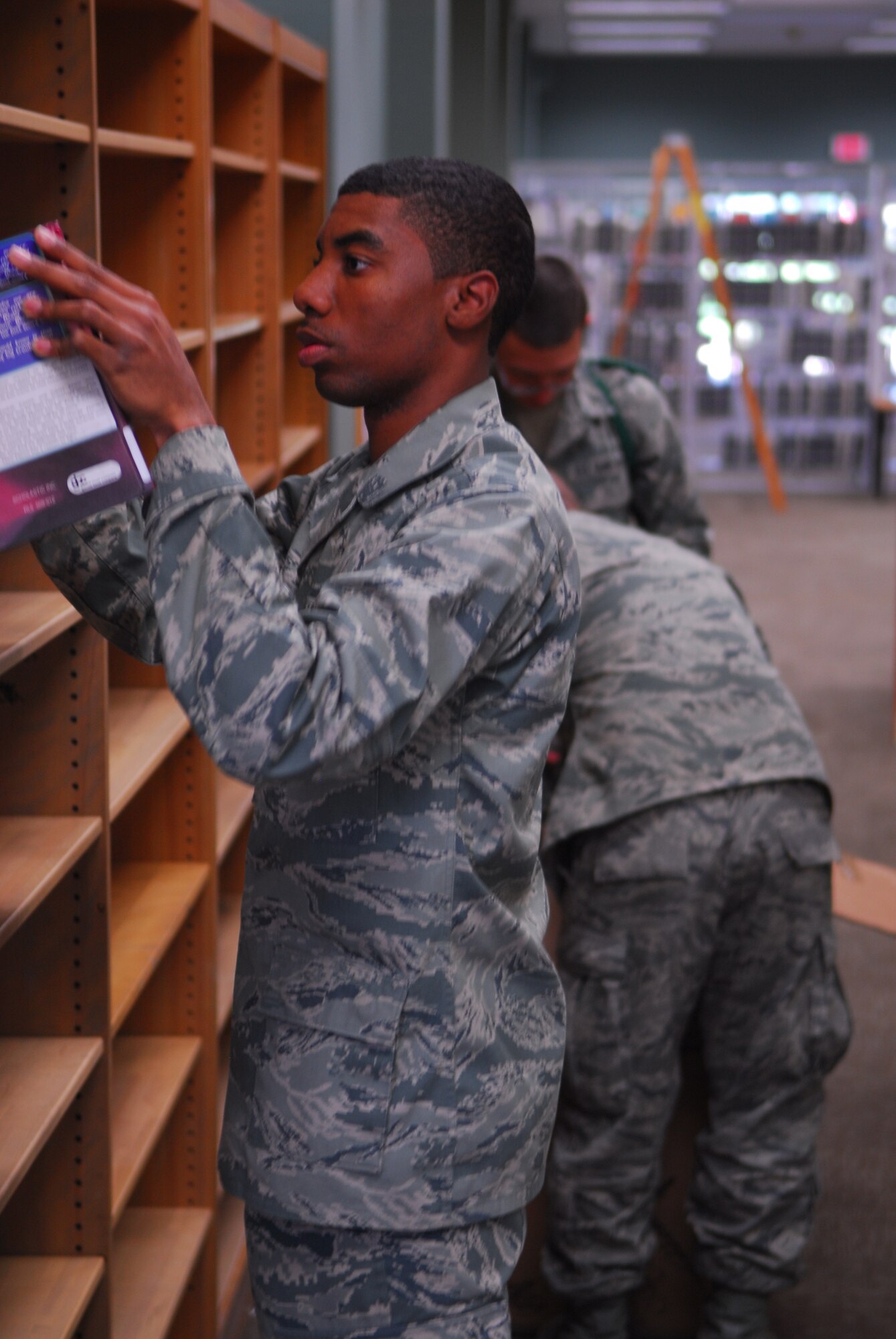 VANDENBERG AIR FORCE BASE, Calif. – Meticulously filing books, Airman Bryan Dowd, a 381st TRSS student, helps in renovation efforts at the base library Wednesday, Oct. 21, 2009. Airmen from Vandenberg’s training squadrons frequently volunteer in the local community. (U.S. Air Force photo/Airman 1st Class Steve Bauer)