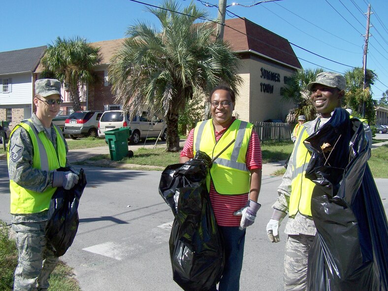 FORT WALTON BEACH, Fla. - Members of the 505th Command and Control Wing clean up debris from the side of James Lee Road on Oct. 16. The 505th Command and Control Squadron adopted the road in the Adopt-A-County Road program and comes out every few months to keep it clean. From left are Master Sgt. Mark Young, Darryl Wilson and Tech. Sgt.  Christopher Arrington. (U.S. Air Force photo by Noel Getlin) 