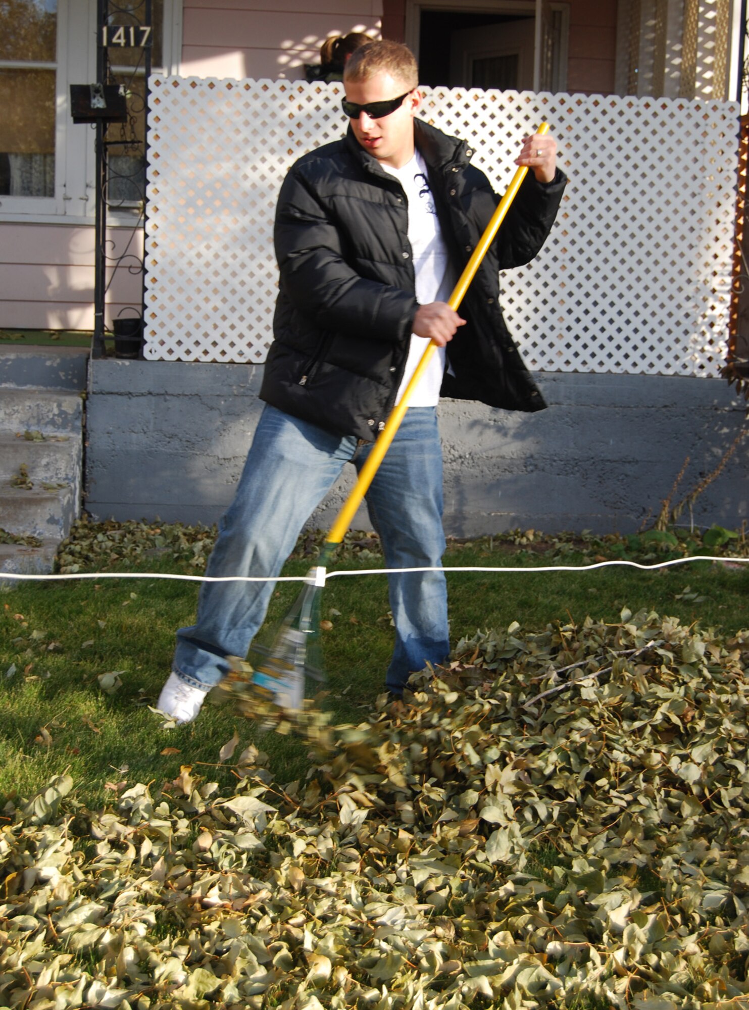 Senior Airman Anthony Pastore, 741st Missile Security Forces Squadron, rakes leaves during the Day of Caring Oct. 16. This is the first year he has participated in the event and said he thinks it's nice to help out people who can't do it themselves. (U.S. Air Force photo/Valerie Mullett)