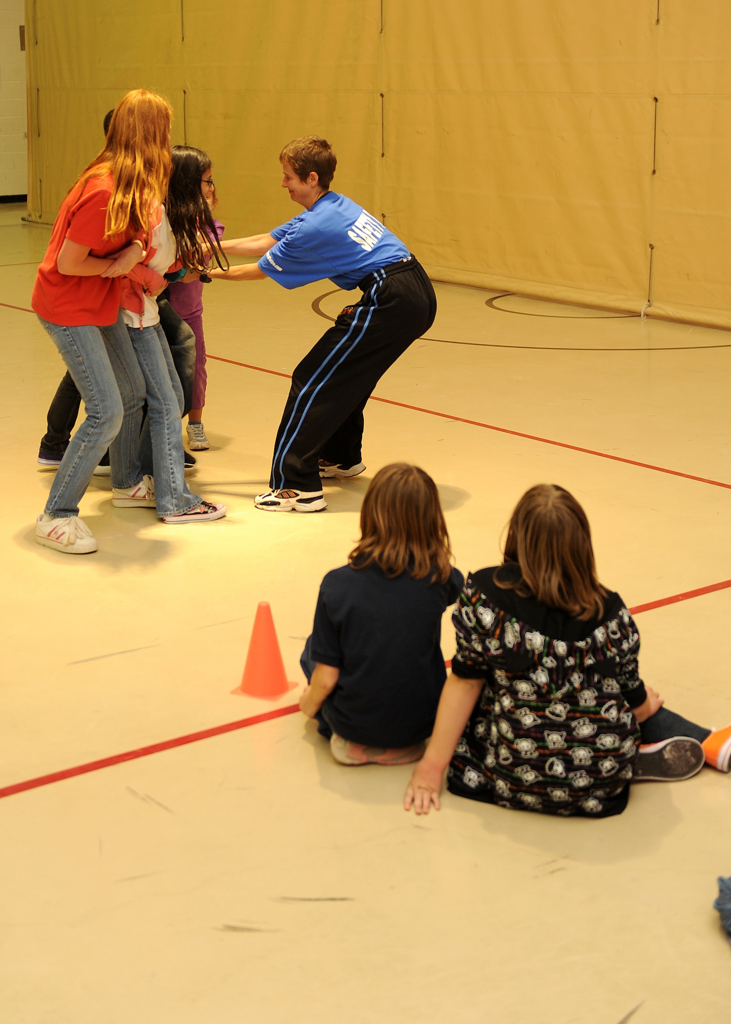 HOLLOMAN AIR FORCE BASE, N.M. -- Children learn to work together by holding on to each other to prevent them from being abducted. The Sexual Assualt Prevention Response office hosted a class on self-defense that covered aspects of personal protection unique to children at the Youth and Teen Center here Oct. 21. The class covered techniques to prevent abduction and escape plans with the help of Overstreet Taekwondo. (U.S. Air Force photo by Senior Airman Michael Means)