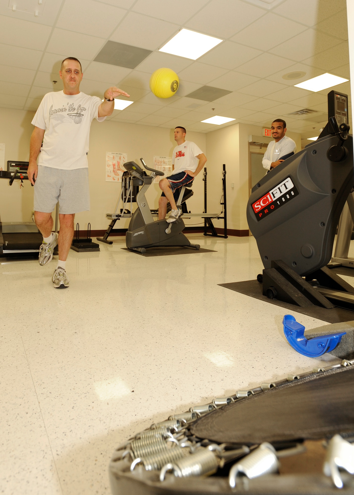 Master Sgt. Curtis Patten, 184th Intelligence Wing, Kansas Air National Guard, tosses a medicine ball at a trampoline to increase his lower body’s stability and balance, Oct. 20, 2009, at the McConnell Air Force Base, Kan., Physical Therapy Clinic. October is National Physical Therapy Month and recognizes physical therapy practice, research and education. (U.S. Air Force photo/Staff Sgt. Jamie Train)
