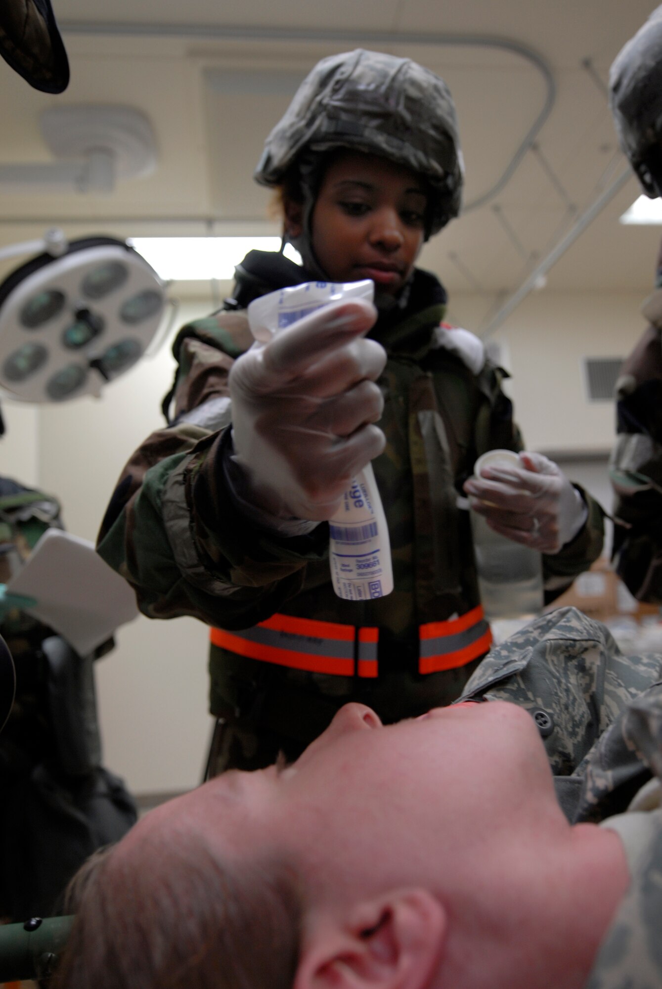 Captain Gregory Skochko from the 18th Medical Group treats a simulated chemical burn during exercise Beverly High 10-01 at Kadena Air Base Oct. 20. The 18th Wing is participating in a Local Operational Readiness Exercise to test the readiness of Kadena Airmen Oct. 19-23. (U.S. Air Force photo / Airman 1st Class Chad Warren)
