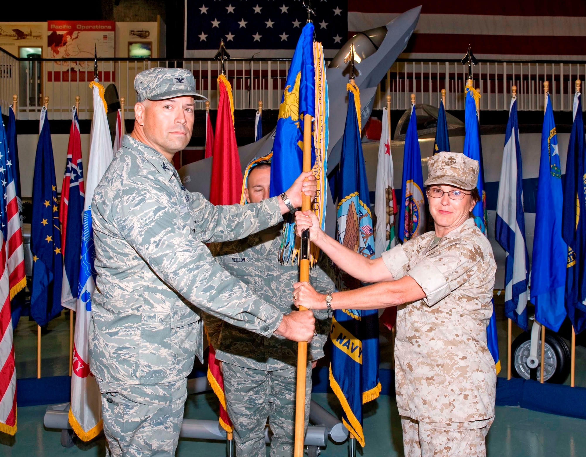 Marine Col. Laura Sampsel, right, receives the flag from Col. David Hlakty, 33rd Fighter Wing commander, during the 33rd Maintenance Group assumption of command ceremony Oct. 16. The 33rd MXG is responsible for the bed-down and operational readiness of the three variants of the Joint Strike Fighter F-35 aircraft. Prior to arriving to Eglin, the colonel commanded the Defense Logistics Information Service, Battle Creek, Mich., and has leadership experience in other Marine Aviation Logistics squadrons and wings. (U.S. Air Force photo/Bruce Hoffman.)