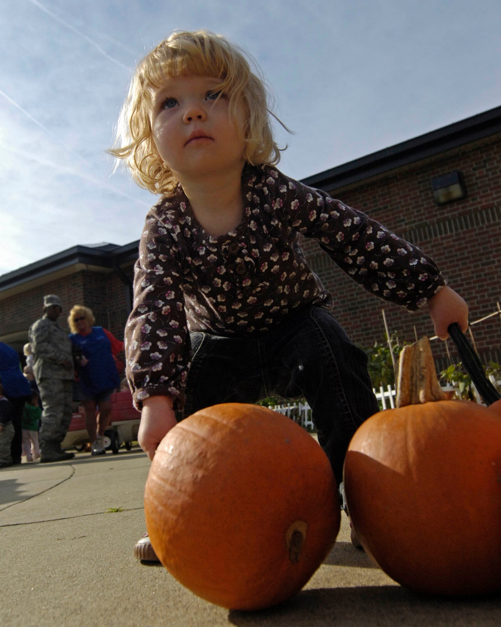 LANGLEY AIR FORCE BASE, Va. -- Emily Croft, age 1, daughter of Senior Master Sgt. Troie Croft, 480th Intelligence Surveillance and Reconnaissance Wing, enjoys a pumpkin display at the Russ and Jean Child Development Center here Oct. 22. The CDC held a Fall Harvest Festival featuring a Virginia Living Museum display, pumpkins, and class photos.  (U.S. Air Force Photo/Airman Rebecca Montez)