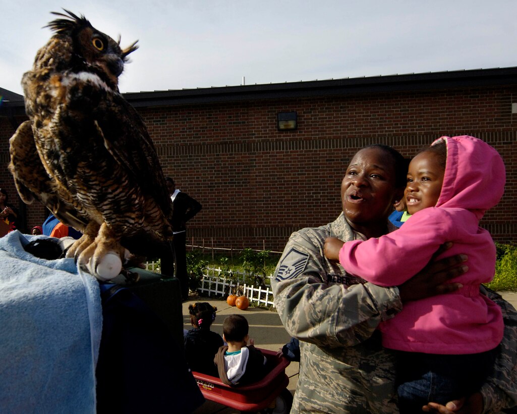 LANGLEY AIR FORCE BASE, Va. -- Master Sgt. Jacqueline Weber, 1st Communications Squadron, and her daughter Rachel, age 3, admire a Great Horned Owl at the Russ and Jean Child Development Center here Oct. 22. Virginia Living Museum personnel brought a travelling display to the CDC’s Fall Harvest Festival.  (U.S. Air Force Photo/Airman Rebecca Montez)
