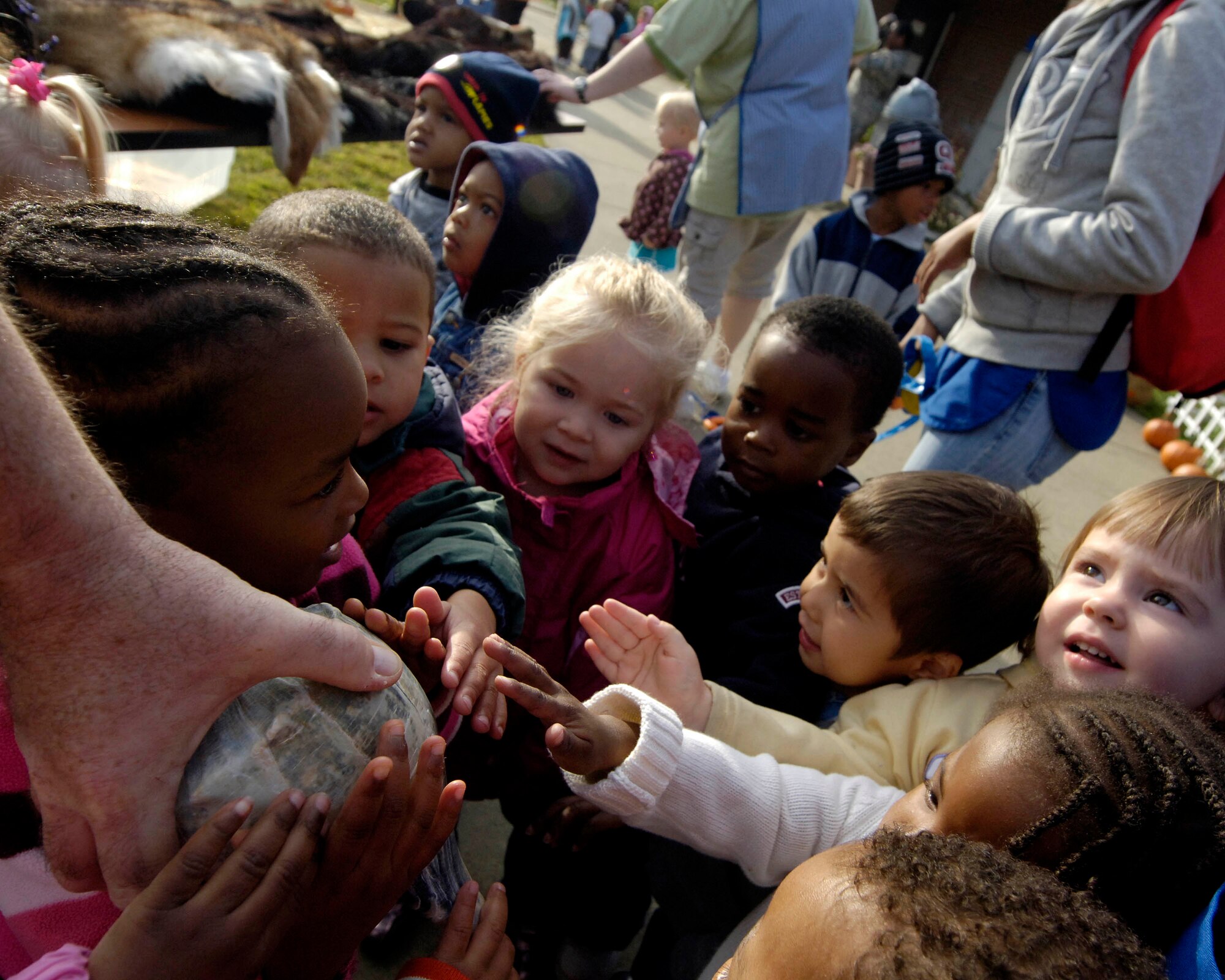 LANGLEY AIR FORCE BASE, Va. -- Bo Baker, Virginia Living Museum education associate, shows children a shell from the Chesapeake Bay at the Russ and Jean Child Development Center here Oct. 22. Museum personnel brought a travelling display to the CDC’s Fall Harvest Festival.  (U.S. Air Force Photo/Airman Rebecca Montez)

