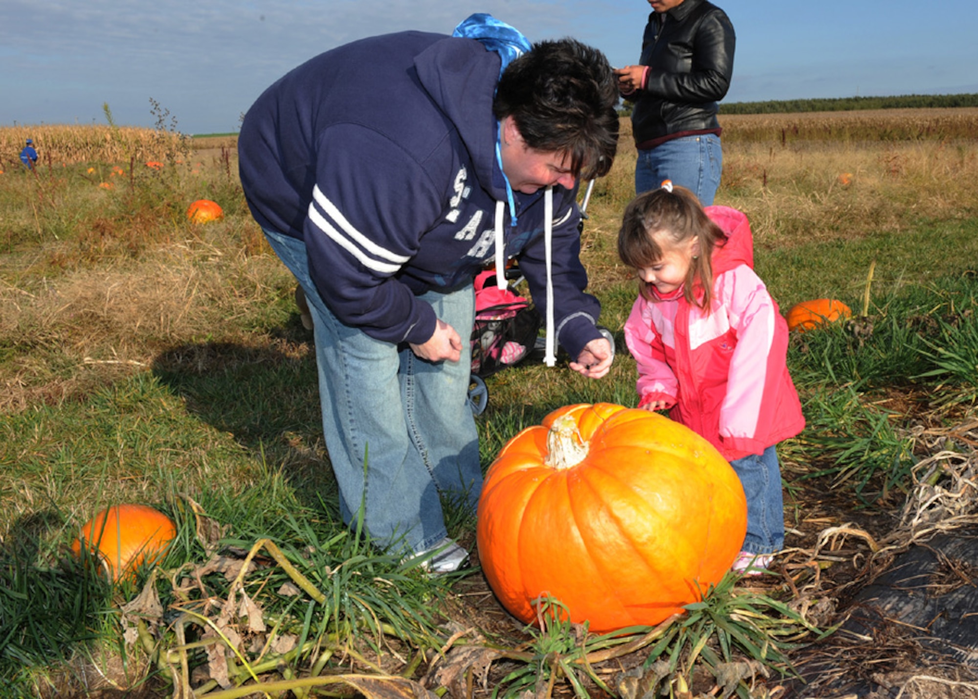 SCOTT AIR FORCE BASE, Ill., -- Briley Tolley and her mother, Melissa, pick a pumpkin Saturday at Eckert's Farm near Belleville, Ill. The Airman and Family Readness Center sponsored a deployed spouses day at the farm where family memebers received free pumpkins. (U.S. Air Force photo/ Tech. Sgt. Michelle Larche)