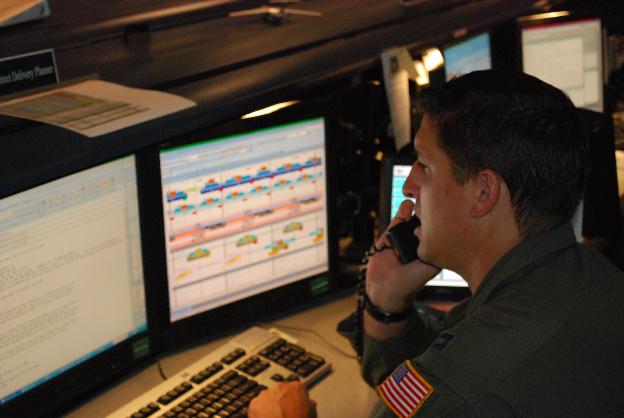 Capt. Joe Aholt, a Theater Direct Delivery Planner at the 618th Tanker Airlift Control Center, coordinates the details of a C-17 Globemaster III cargo mission scheduled to fly in support of Operation Enduring Freedom.  C-17s flying TDD missions have flown nearly 12,000 sorties in 2009, delivering more than 421,000 passengers and 113,000 tons of cargo throughout the U.S. Central Command area of responsibility. The 618th TACC is 18th Air Force’s 24-hour Air and Space Operations Center, located at Scott Air Force Base, Ill. (U.S. Air Force photo/Capt. Justin Brockhoff)