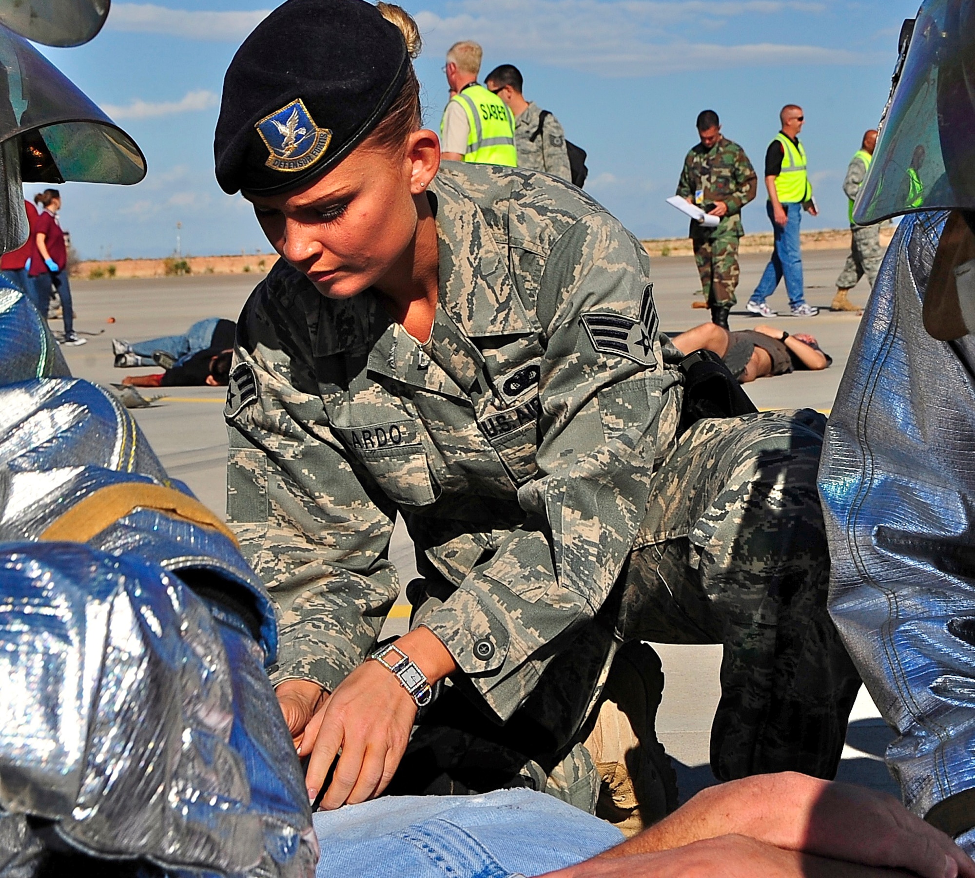 HOLLOMAN AIR FORCE BASE, N.M. -- Senior Airman Gillian Gallardo, 49th Security Forces Squadron, assists fire and emergency service personnel during a Major Accident Response Exercise here Oct. 20. The MARE was designed to prepare Team Holloman for any event that could occur during the upcoming Open House. (U.S. Air Force photo by Tech. Sgt. Chris Flahive)