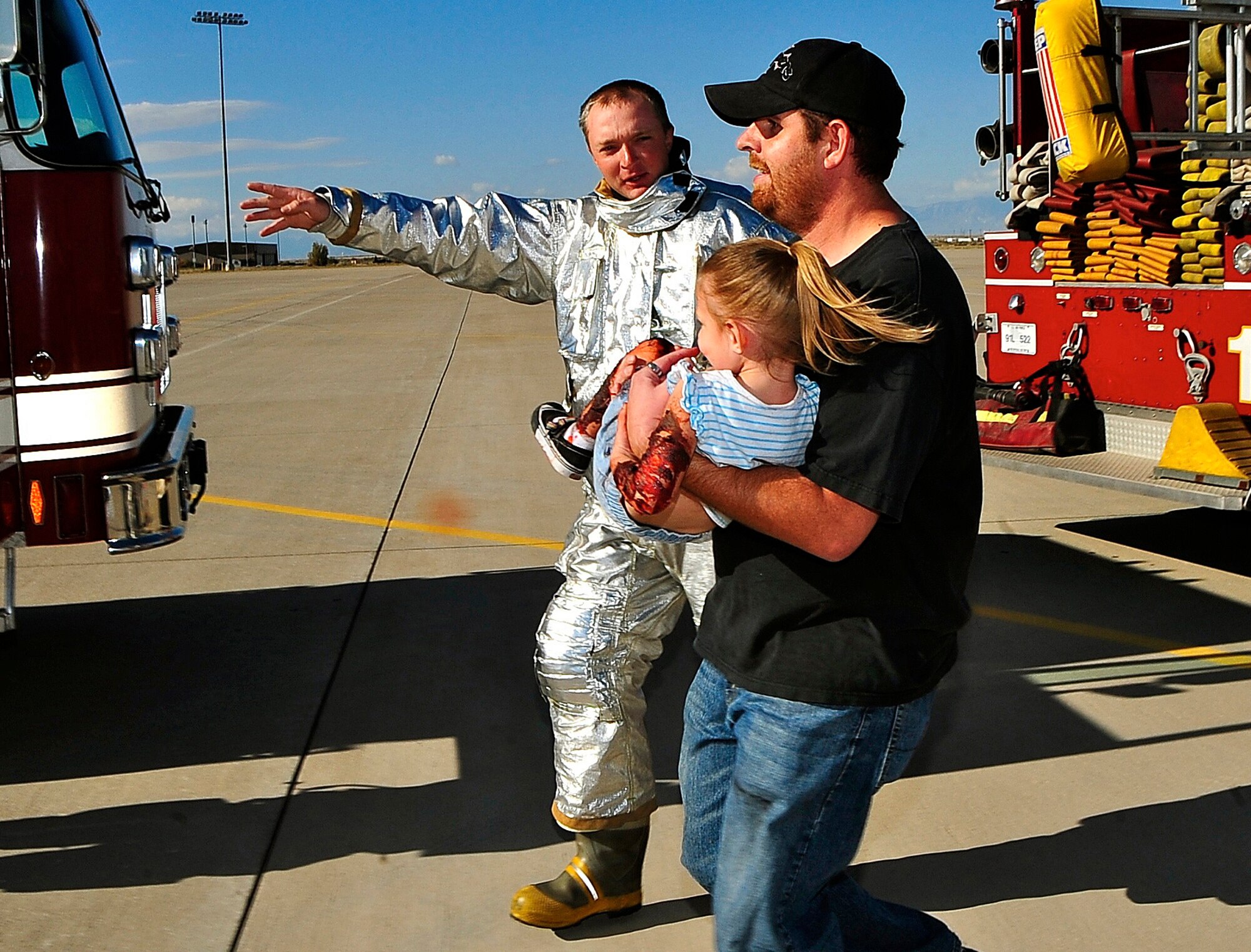HOLLOMAN AIR FORCE BASE, N.M. -- Chad Schumpert, a firefighter with the 49th Civil Engineer Squadron, directs simulated victims during a Major Accident Response Exercise here Oct. 20. Holloman personnel and dependants played as injured bystanders during the exercise to create a realistic emergency situation. The MARE was designed to prepare Team Holloman for any event that could occur during the upcoming Open House. (U.S. Air Force photo by Tech. Sgt. Chris Flahive)