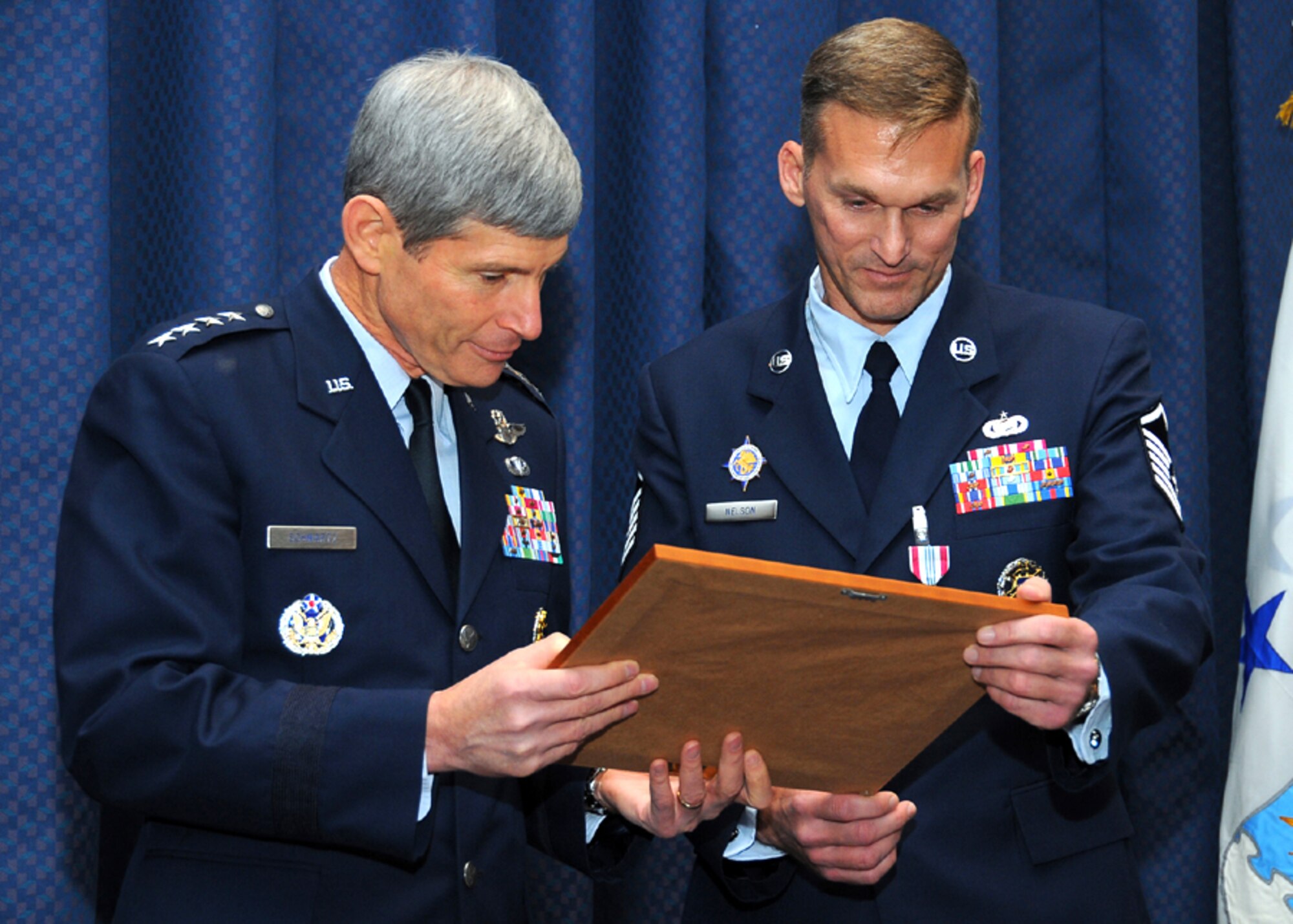 SCOTT AIR FORCE BASE, Ill., -- Air Force Chief of Staff Gen. Norton A. Schwartz and Master Sgt. Randall "Moose" Nelson, read Sgt. Nelson's retirement certificate, Friday, in the U.S. Transportation Command's Seay Auditorium. Gen. Schwartz was at USTRANSCOM to officiate at the retirement of his former aide, Sgt. Nelson, who retired after more than 22 years on active duty.
U.S Air Force photo/ Bob Fehringer 