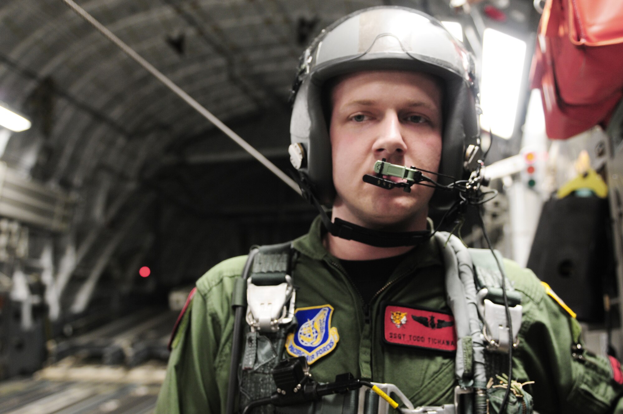 Staff Sgt. Todd Tichawa prepares to open the bay doors to a C-17 Globemaster III during the first combined high-altitude low-opening mission of exercise Cope India Oct. 19, 2009. Sergeant Tichawa is a loadmaster from the 535th Airlift Squadron at Hickam Air Force Base, Hawaii. Cope India is humanitarian assistance disaster relief exercise. (U.S. Air Force photo/Capt. Genieve David)