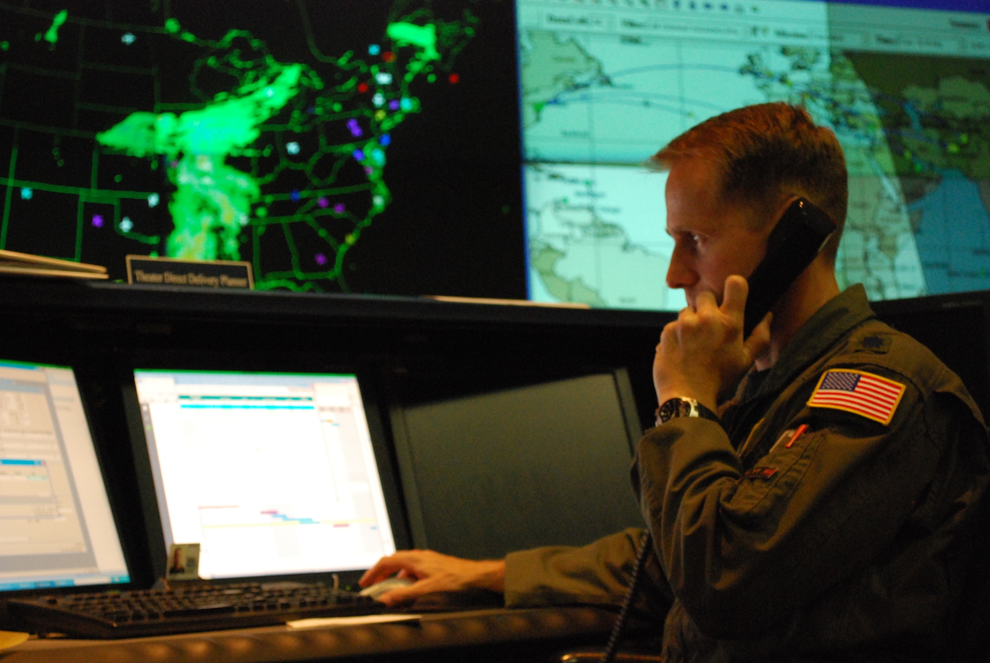 Lt. Col. John Keagle, a Theater Direct Delivery Planner at the 618th Tanker Airlift Control Center, talks with a C-17 Globemaster III pilot about a cargo mission scheduled to deliver supplies to troops in Afghanistan.  C-17s flying TDD missions have flown nearly 12,000 sorties in 2009, delivering more than 421,000 passengers and 113,000 tons of cargo throughout the U.S. Central Command area of responsibility. The 618th TACC is 18th Air Force’s 24-hour Air and Space Operations Center, located at Scott Air Force Base, Ill. (U.S. Air Force photo/Capt. Justin Brockhoff)
