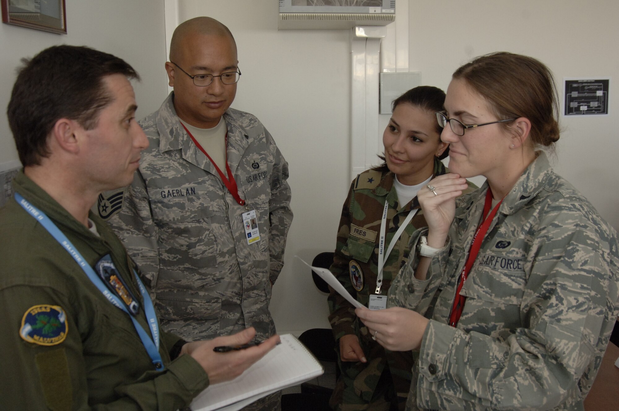 ANTOFAGASTA, Chile -- (From left to right) Maj. Gianotti Javier, Argentinian Air Force, Staff Sgt. Drew Gaerlan, 612th Air Operations Center, 2nd Lt. Stephanie Fres, Fuerza Aérea de Chile or FACH, and Capt. Nicole Golden, 612th AOC, discuss intelligence planning Oct. 20 at Cerro Moreno Air Base during SALITRE, a multinational exercise sponsored by Chile to promote interoperability. Chile, Brazil, France, Argentina and the United States are participating in the exercise. (U.S. Air Force photo by Tech. Sgt. Eric Petosky)