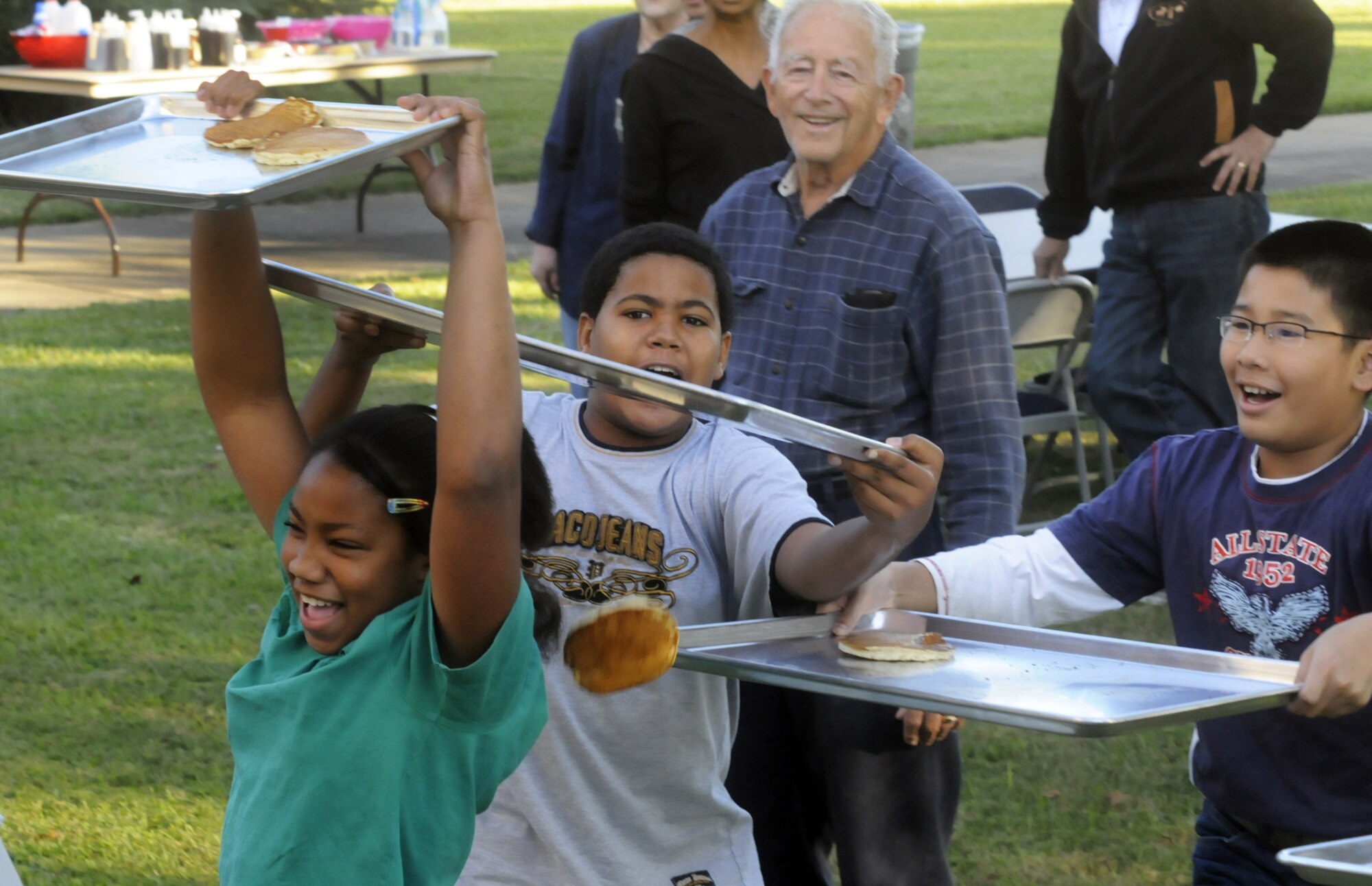 Children used trays to catch some of the flying pancakes. U. S. Air Force photo by Sue Sapp