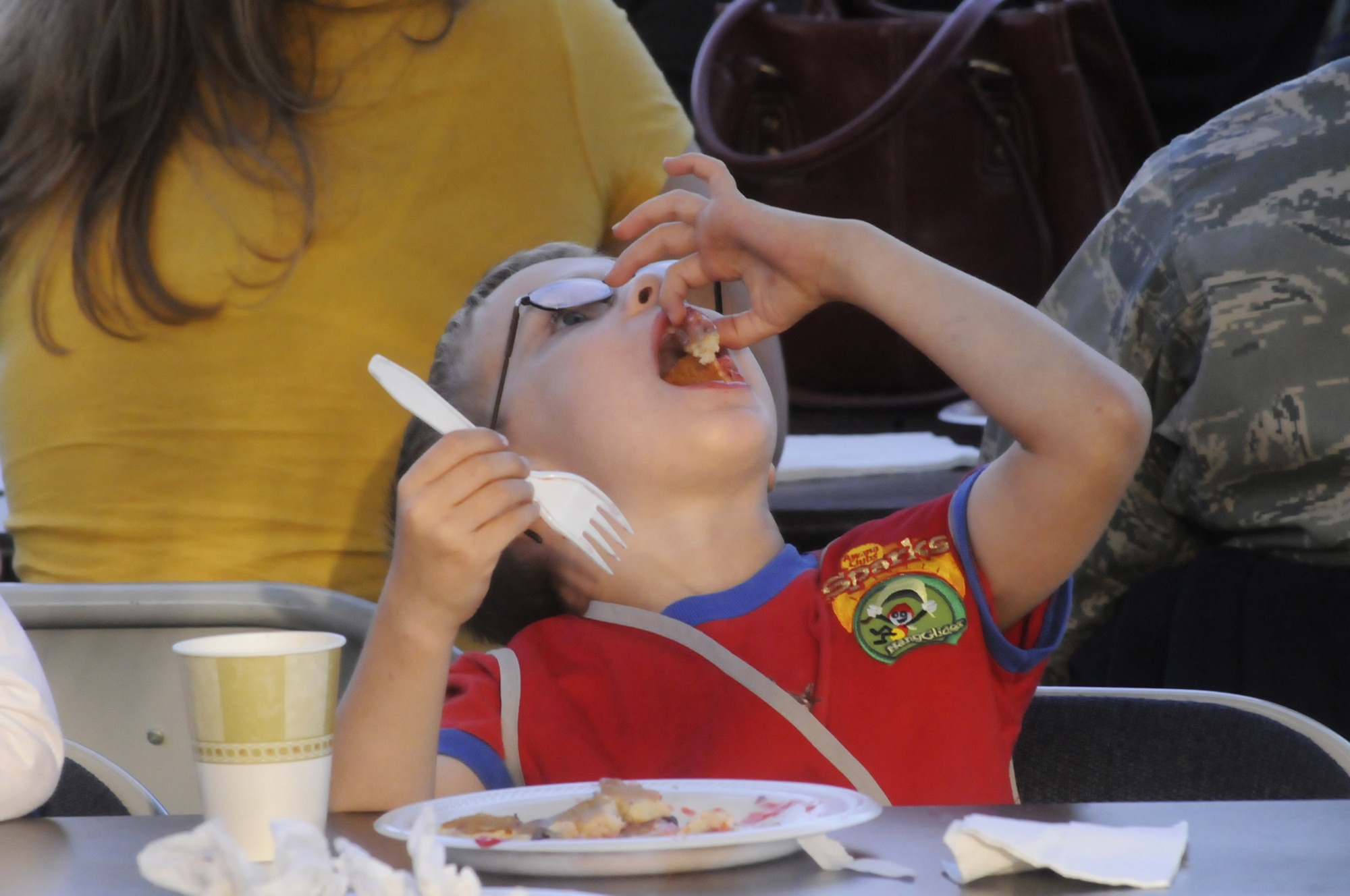 Sam Shelton, 5, chows down on his pancakes. Sam caught 3 pancakes and said they tasted "good". U. S. Air Force photo by Sue Sapp