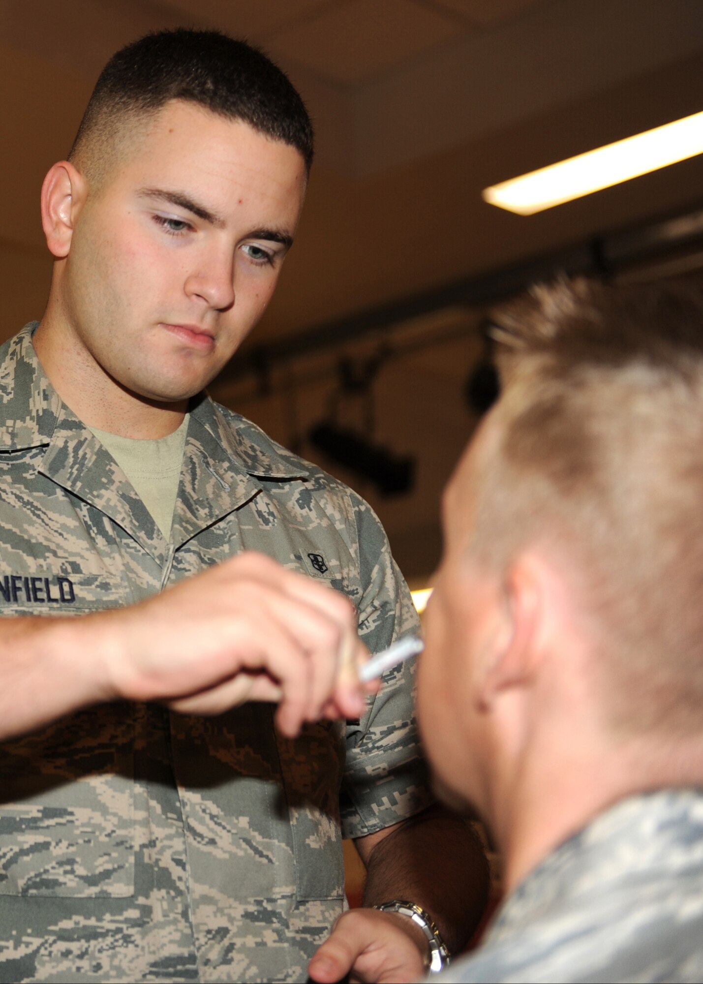 HOLLOMAN AIR FORCE BASE, N.M. -- Airman 1st Class Eric Canfield, 49th Medical Operations Squadron, administers a Team Holloman member with the seasonal FluMist vaccine Oct. 21 at the Community Activity Center here. Vaccinations started on Oct. 20 at 2 p.m. and are being given for 48 hours straight at the center. The 49th Medical Group is using this 48 hour period to exercise its real world capabilities to immunize and track the base populous in case of a potential disease outbreak. The goal was to vaccinate 90 percent of available active duty Air Force personnel assigned to Holloman. (U.S. Air Force photo by Senior Airman Michael Means)