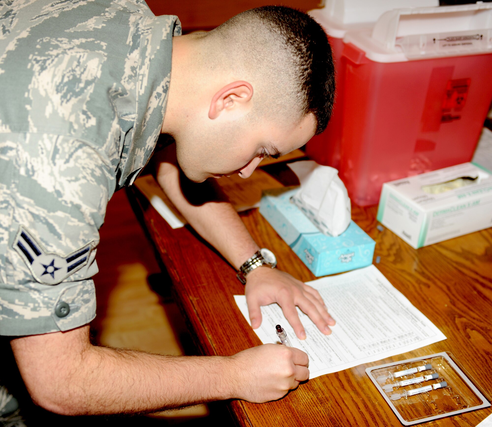 HOLLOMAN AIR FORCE BASE, N.M. -- Airman 1st Class Eric Canfield, 49th Medical Operations Squadron, looks over paperwork Oct. 21 to track personnel here who receive the seasonal FluMist vaccine. Vaccinations started Oct. 20 at 2 p.m. and are being given at the Community Activity Center over a 48 hour period. The 49th Medical Group is using this 48 hour period to exercise its real world capabilities to immunize and track the base populous in case of a potential disease outbreak. The goal was to vaccinate 90 percent of available active duty Air Force personnel assigned to Holloman. (U.S. Air Force photo by Senior Airman Michael Means)