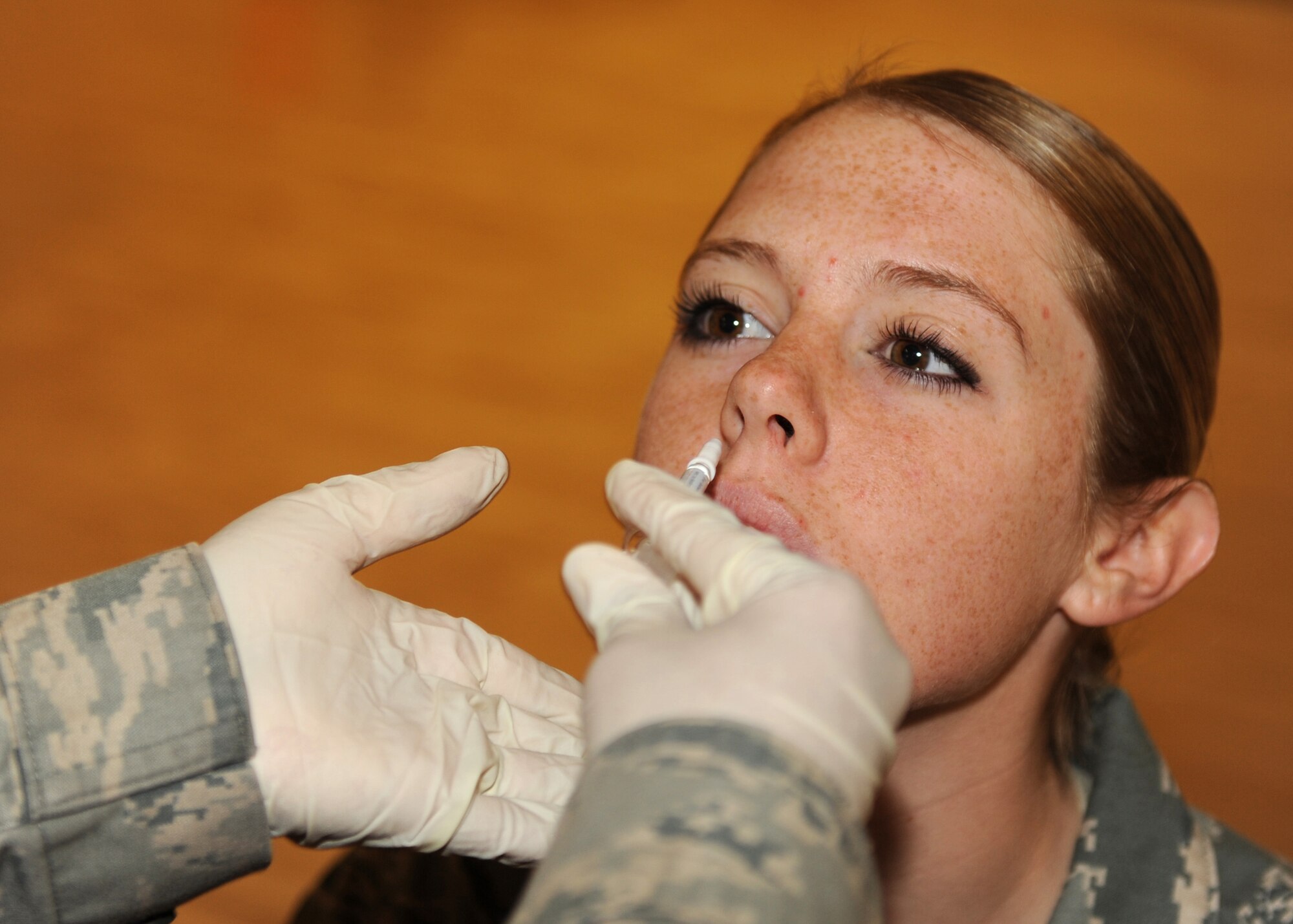 HOLLOMAN AIR FORCE BASE, N.M. -- Airman 1st Class Sondra Escutia, 49th Fighter Wing, receives the seasonal FluMist vaccine Oct. 21 at the Community Activity Center here. Vaccinations started on Oct. 20 at 2 p.m. and are being given at the center over a 48 hour period. The 49th Medical Group is using this 48 hour period to exercise its real world capabilities to immunize and track the base populous in case of a potential disease outbreak. The goal is to vaccinate 90 percent of available active duty Air Force personnel assigned to Holloman. (U.S. Air Force photo by Senior Airman Michael Means)