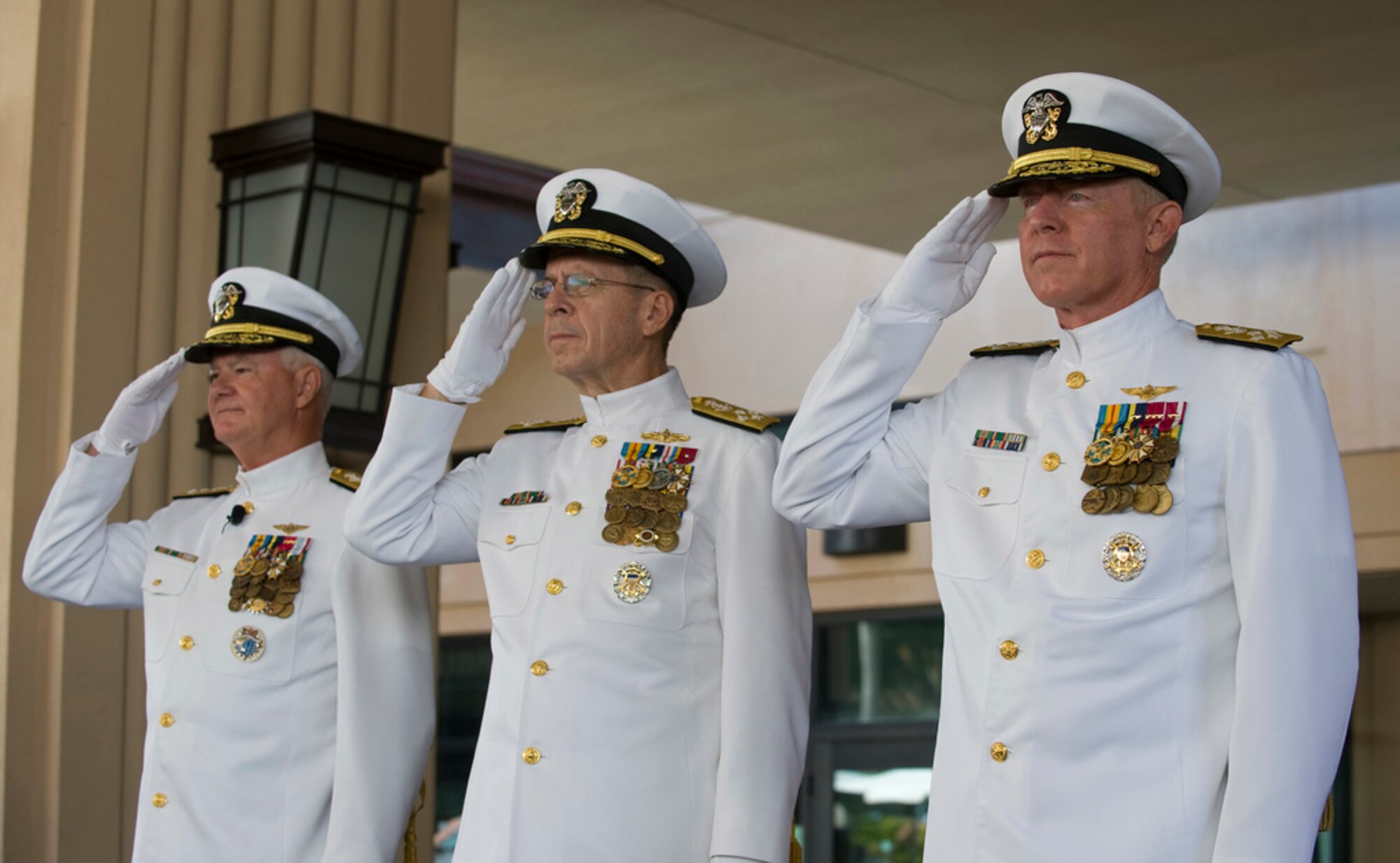 Adm. Robert F. Willard (from right), incoming commander of U.S. Pacific Command; Adm. Mike Mullen, chairman of the Joint Chiefs of Staff; and Adm. Timothy J. Keating, outgoing commander of U.S. PaCom, render honors during the singing of the national anthem at the U.S. PaCom change of command ceremony Oct. 19, 2009, at Camp H.M. Smith, Hawaii. Admiral Willard, former U.S. Pacific Fleet commander, assumed command of U.S. PaCom from Admiral Keating during the ceremony.  (U.S. Navy photo/Navy Petty Officer 2nd Class Elisia V Gonzales)