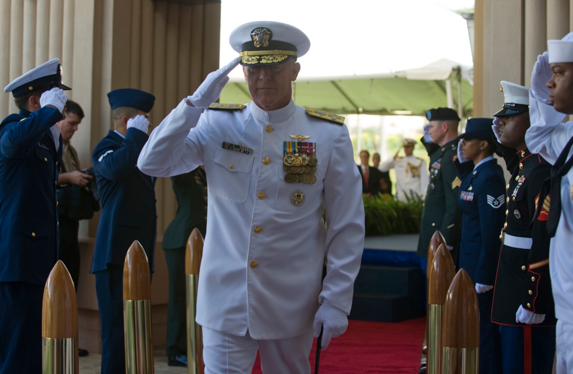Adm. Robert F. Willard, incoming commander of U.S. Pacific Command, renders a salute as he passes through side boys during the U.S. PaCom change of command ceremony Oct. 19, 2009, at Camp H.M. Smith, Hawaii. Admiral Willard, former U.S. Pacific Fleet commander, assumed command of U.S. PaCom from Adm. Timothy J. Keating during the ceremony. (U.S. Navy photo/Navy Petty Officer 2nd Class Elisia V Gonzales)