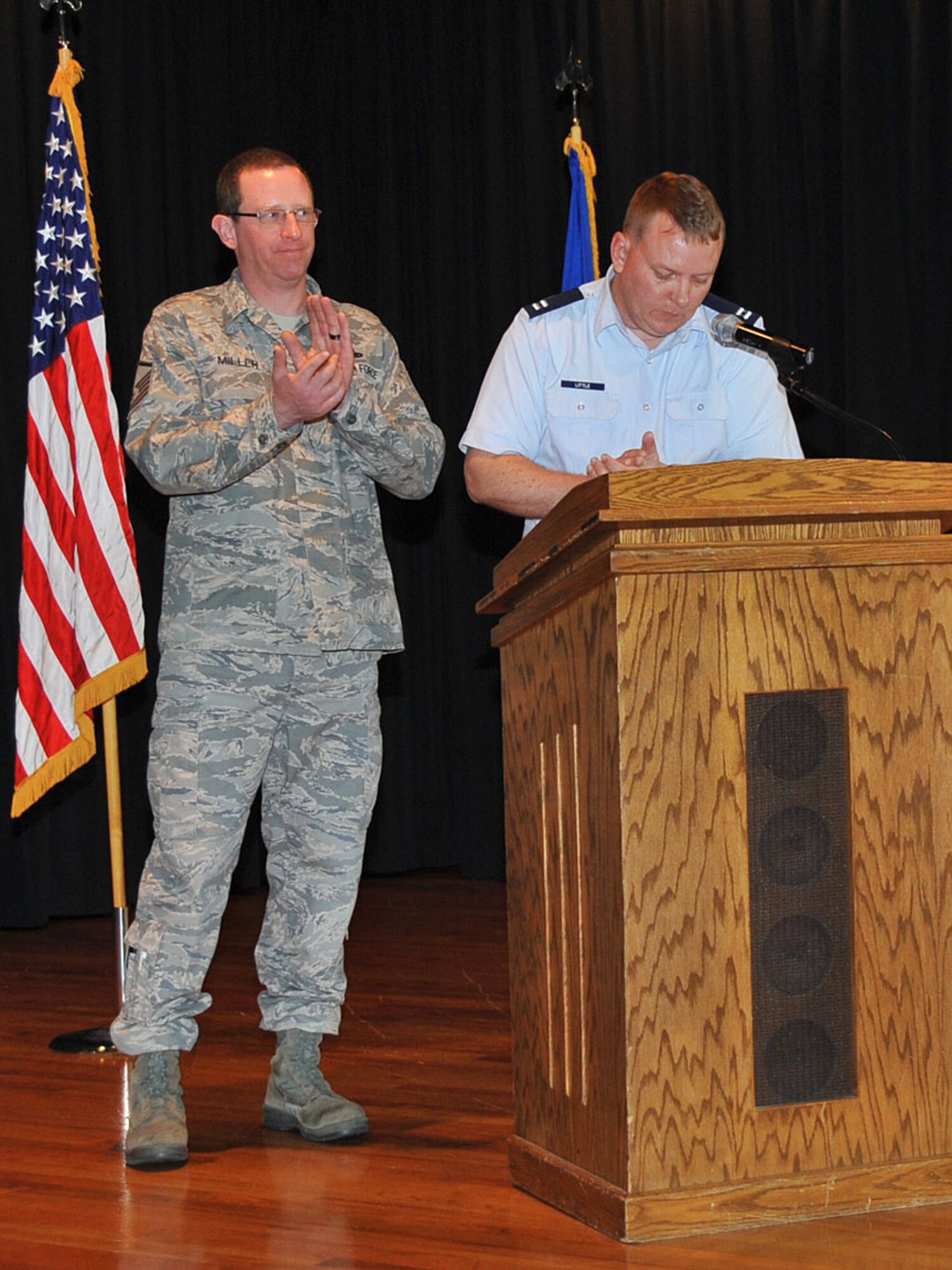 FAIRCHILD AIR FORCE BASE, Wash. – Capt. Glenn Little, 92nd Medical Operations Squadron, and Master Sgt. Christopher Miller, 92nd Aircraft Maintenance Squadron, applauds the donation efforts of Fairchild during the Combined Federal Campaign official kick off Oct. 13 at the Deel Community center. CFC is the world's largest annual workplace charity campaign. Pledges made by federal, civilian, postal and military donor’s campaign support eligible non-profit organizations that provide health and human service benefits throughout the world. (U.S. Air Force photo / Staff Sgt. JT May III)

