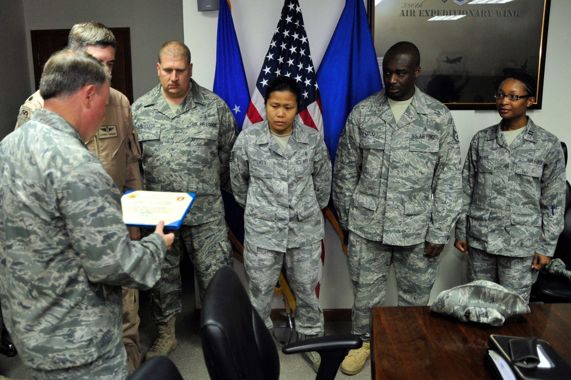 SOUTHWEST ASIA -Brig. Gen. Bryan Benson, 380th Air Expeditionary Wing commander, presents the 380th Expeditionary Medical Group clinic staff, with the AFCENT Air Force Forward Surgeon General Team Award Oct. 21, 2009. The clinic team members include Lt. Col. Stephen Hingson, Capt. Filita Moore, Master Sgt. Leonel Gonzalez, Tech. Sgt.  Christopher Archuleta, Tech. Sgt. Genevieve Storey and Staff Sgt. Eric Otoo. (U.S. Air Force photo/Tech. Sgt. Charles Larkin Sr)