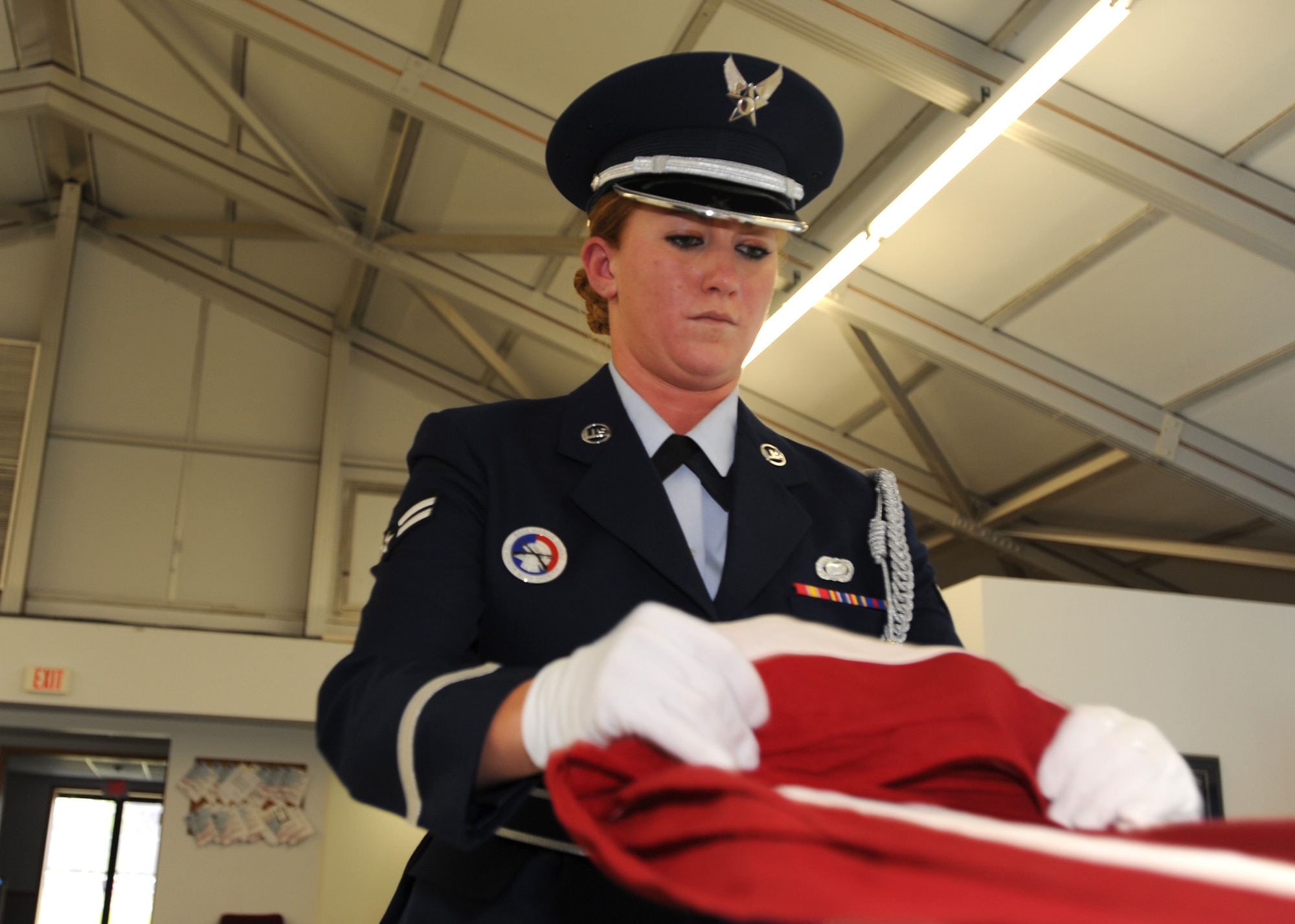 Airman 1st Class Crystal D. Dail, 319th Maintenance Group, practices the proper way to fold a flag Oct. 9 on Grand Forks Air Force Base, N.D. Airman Dail was announced as the base’s third quarter Honor Guard Member of the Quarter. (U.S. Air Force photo by Staff Sgt. Suellyn F. Nuckolls)