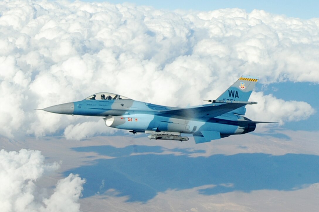 An F-16 Fighting Falcon Aggressor flies over the Nevada Test and Training Range after being refueled by an Ohio Air National Guard KC-135 Stratotanker Oct. 19, 2009. Red Flag 10-01 is a realistic combat training exercise involving the air forces of the United States and its allies. The exercise is conducted on the 15,000-square-mile Nevada Test and Training Range, north of Las Vegas. (U.S. Air Force photo/Airman 1st Class Jamie Nicley)