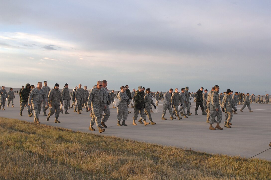 ELLSWORTH AFB, SD--Members of the 28th Bomb Wing perform a Foreign Object Damage walk on the Ellsworth Air Force Base flightline, Oct 19. FOD detection saves the Air Force millions of dollars each year in extra parts and unscheduled maintenance and FOD prevention is in the forefront of all flightline activities at Ellsworth. (U.S. Air Force photo/Master Sgt. Loren J. Bonser)