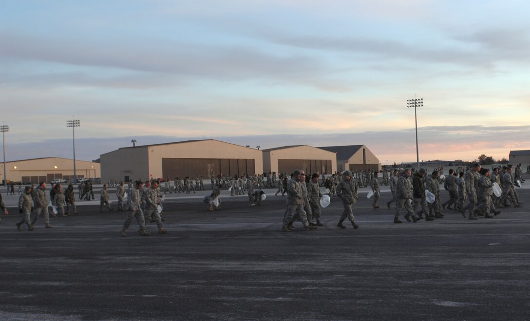 ELLSWORTH AFB, SD--Members of the 28th Bomb Wing perform a Foreign Object Damage walk on the Ellsworth Air Force Base flightline, Oct 19. FOD detection saves the Air Force millions of dollars each year in extra parts and unscheduled maintenance and FOD prevention is in the forefront of all flightline activities at Ellsworth. (U.S. Air Force photo/Master Sgt. Loren J. Bonser)